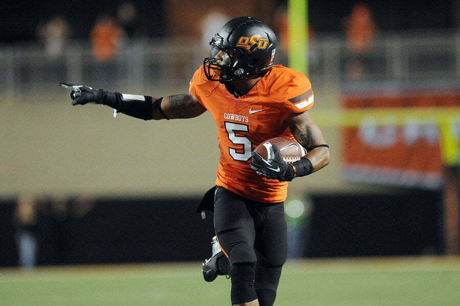 Sept 29, 2012; Stillwater, OK, USA; Oklahoma State Cowboys reciever Josh Stewart (5) runs after a catch while being defended by the Texas Longhorns during the first half at Boone Pickens Stadium. Mandatory Credit: Mark D. Smith-US PRESSWIRE